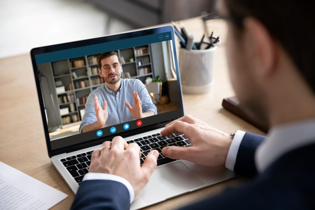 two business men have a conversation during a virtual meeting