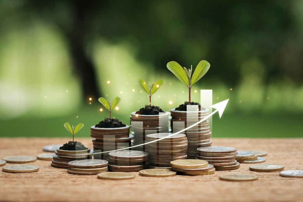 Tree on pile of coins and uptrend chart green business idea Sustainability Finance and Investment and Carbon Credits